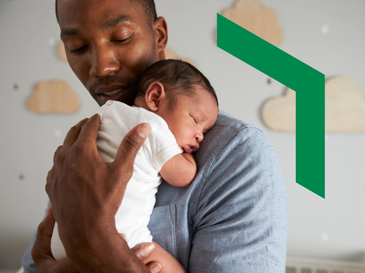 A father holds his newborn baby.