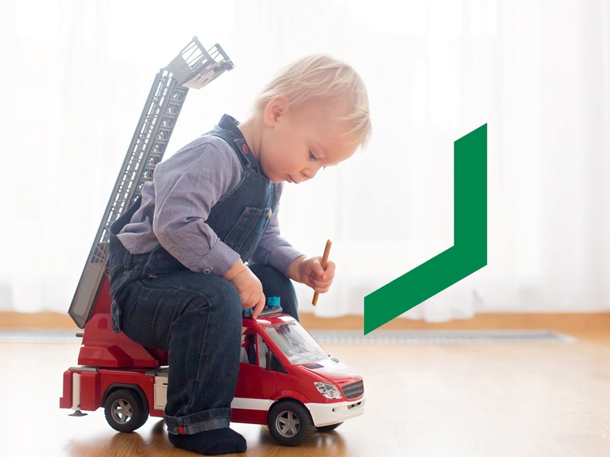 A toddler plays with a fire truck